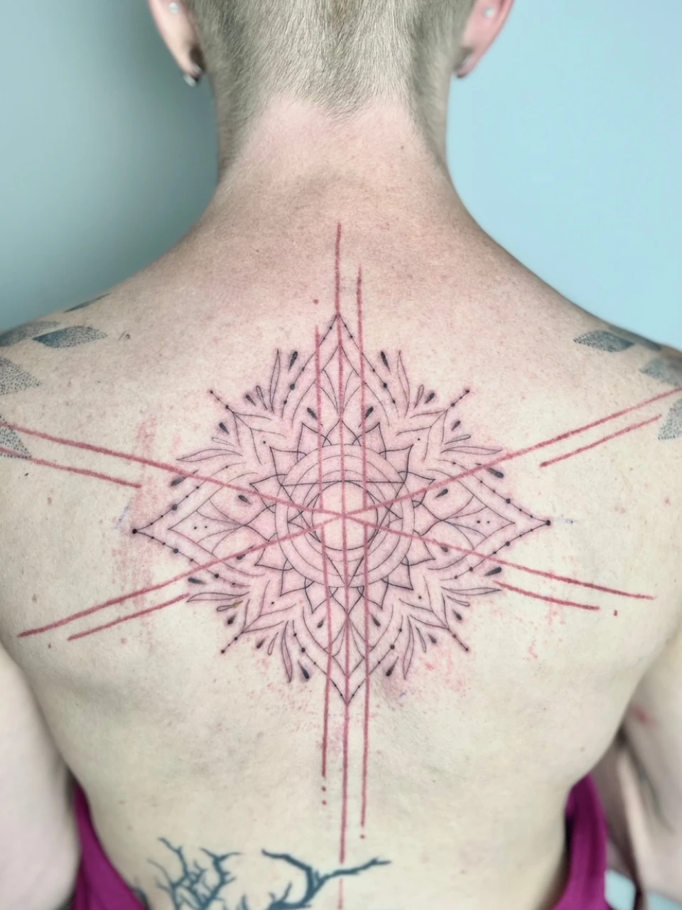 geometric ornament / mandala tattoo on the back