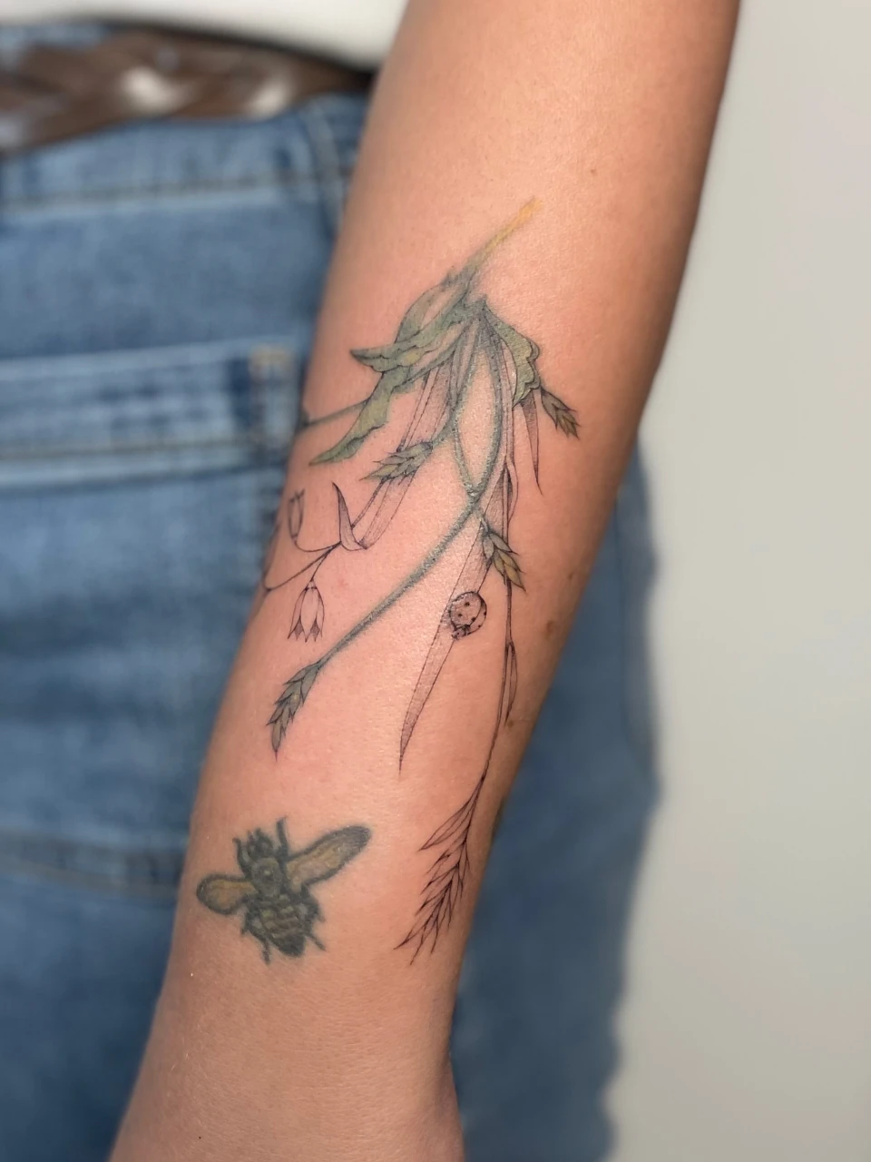 flower fine line tattoo on forearm