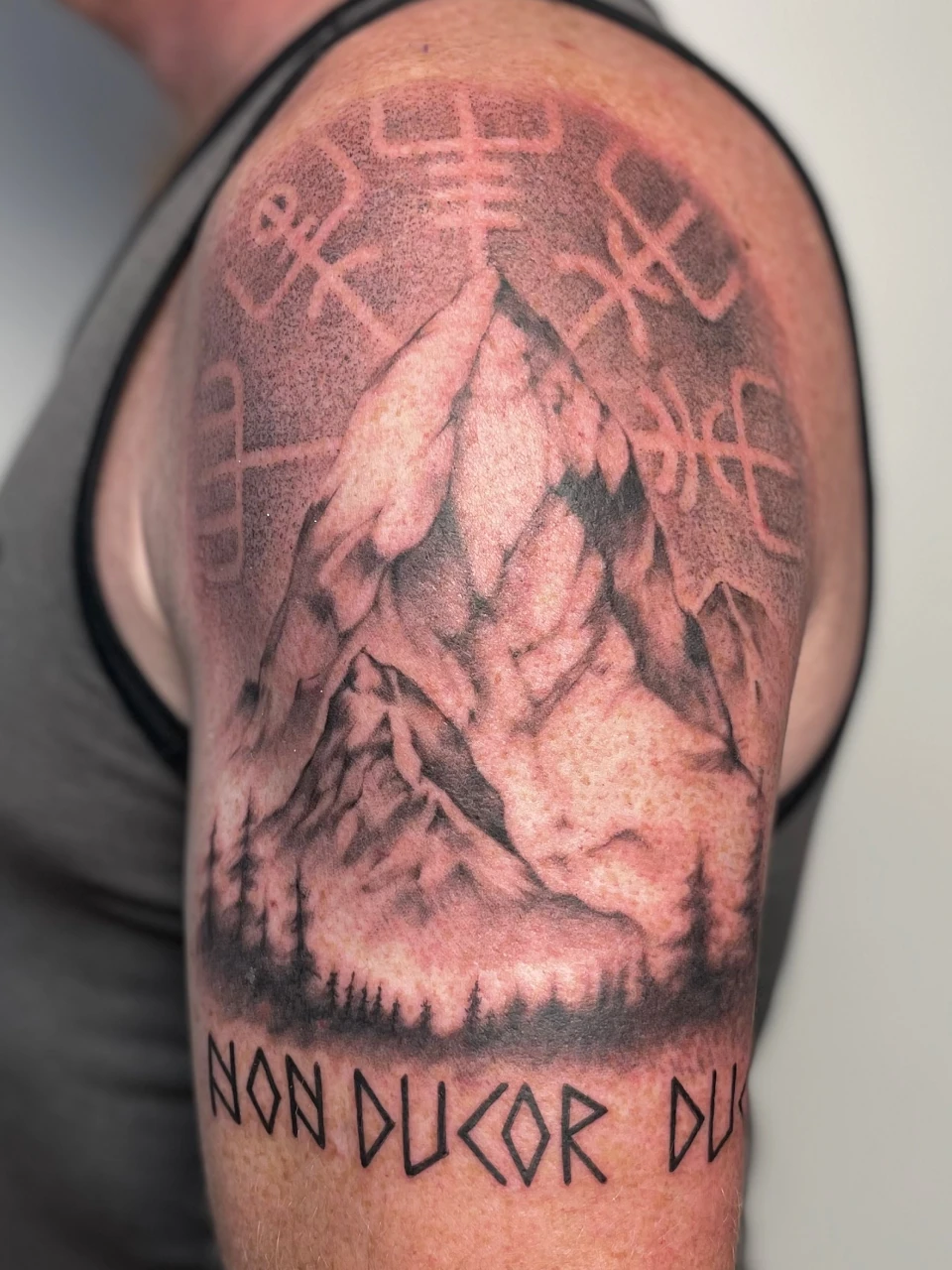 tribal with mountain tattoo on arm