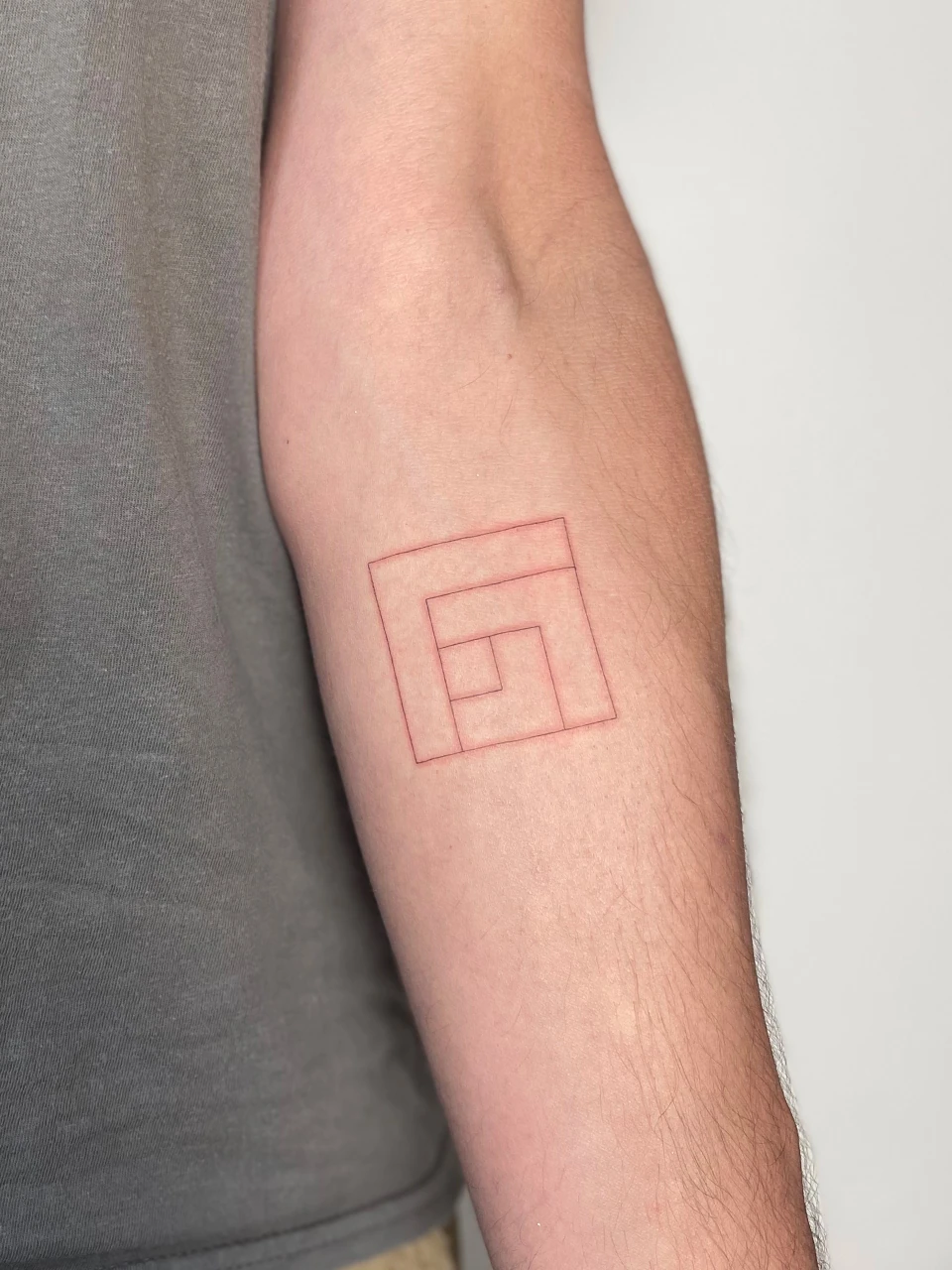 geometric fine line tattoo on arm