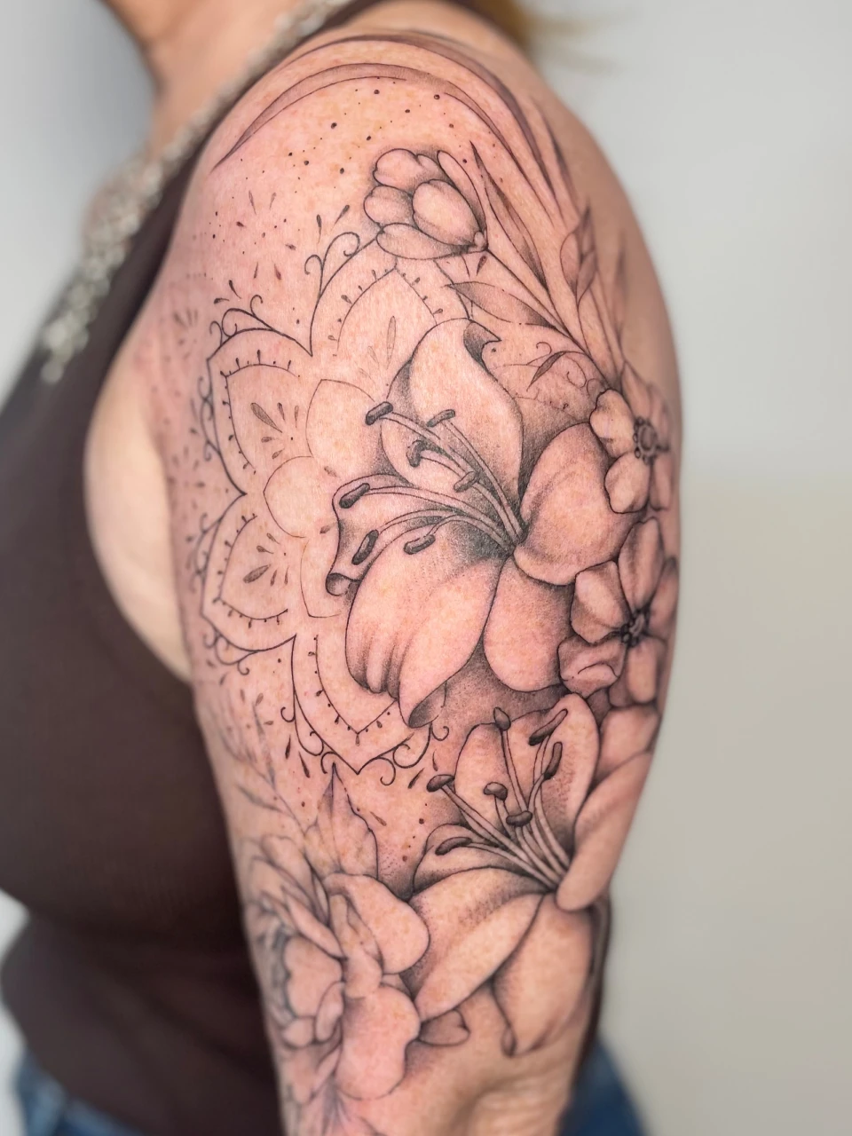 floral bouquet fine line tattoo on arm
